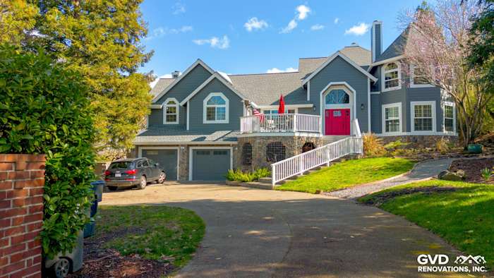 Home exterior showcasing Night Gray James Hardie siding with Arctic White trim and a vibrant pink front door