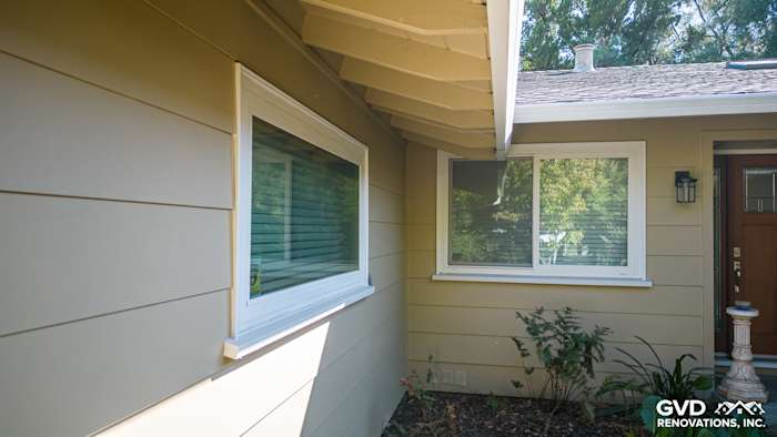 Carmichael home's exterior showcasing James Hardie siding and trim around windows in soft beige tones