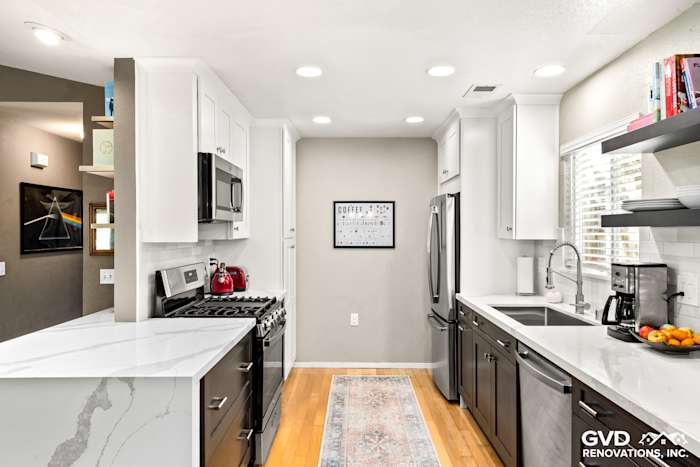 Modern kitchen remodel in Davis featuring white cabinets, quartz countertops, and stainless steel appliances