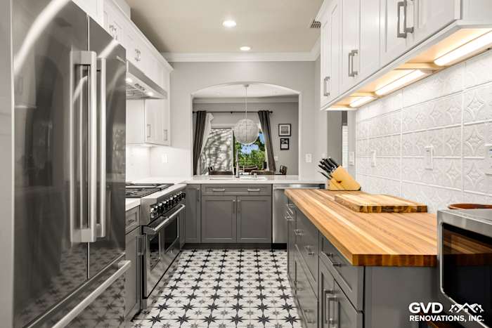 Modern kitchen remodel featuring gray cabinets, stainless steel appliances, and a patterned floor in Folsom, CA