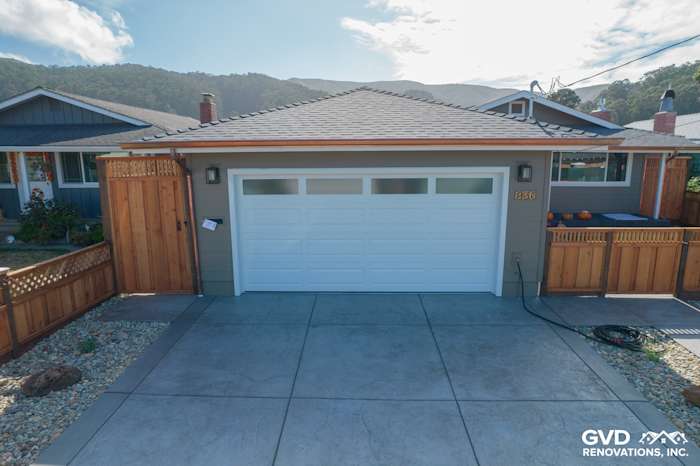 Modern home exterior featuring Timber Bark siding, Arctic White trim, new Anlin Catalina windows, and a sleek garage door