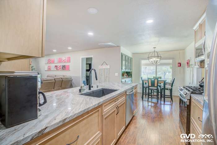Modern kitchen remodel featuring quartz countertops, stainless steel appliances, and hardwood flooring in Sacramento