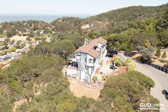 Home exterior featuring Arctic White James Hardie Lap Siding, surrounded by landscaping and hillside views in San Rafael