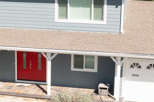 Two-story home exterior featuring Boothbay Blue James Hardie siding, Arctic White trim, and Milgard windows in Concord, CA
