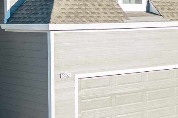 Modern home exterior featuring James Hardie Aged Pewter siding and a unique gabled roof in Santa Rosa