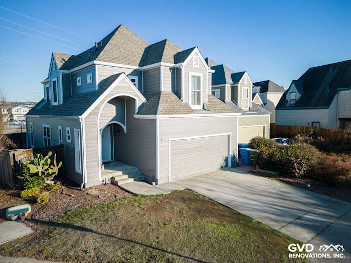 Modern home exterior featuring James Hardie Aged Pewter siding and a unique gabled roof in Santa Rosa