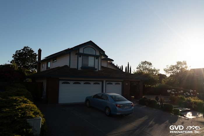 Two-story home with Arctic White James Hardie siding, landscaped yard, and driveway in Hercules, CA