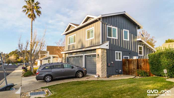 Dublin home with newly installed James Hardie Night Gray siding and Arctic White trim, featuring a stone accent wall
