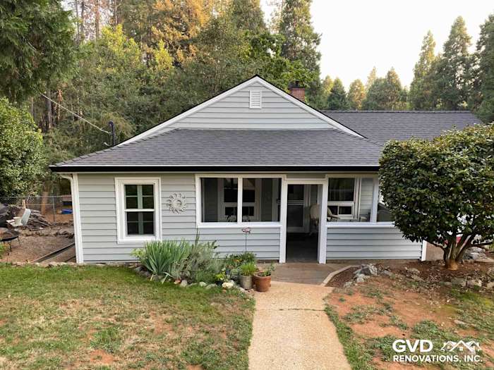 Stylish home exterior in Grass Valley featuring light gray Prodigy Vinyl Siding and a landscaped entryway