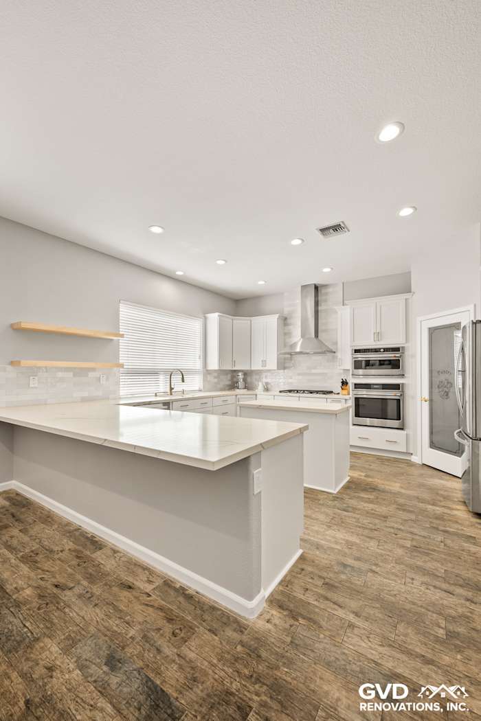 Modern kitchen remodel in Roseville featuring Diamond cabinets, MSI countertops, and full-height backsplash with mitered