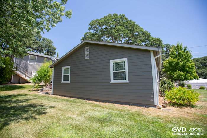 Auburn home with Aged Pewter HardiePlank siding and Arctic White trim, surrounded by green landscaping