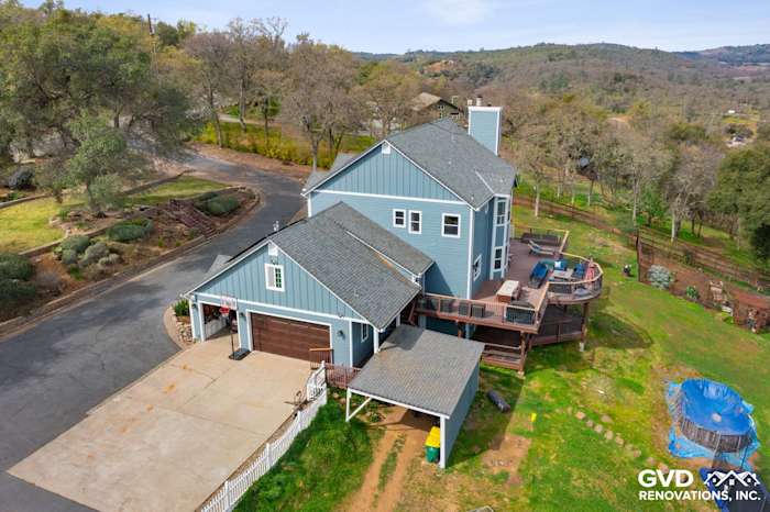 Stylish home exterior featuring new blue James Hardie siding and a spacious backyard deck in Shingle Springs, CA