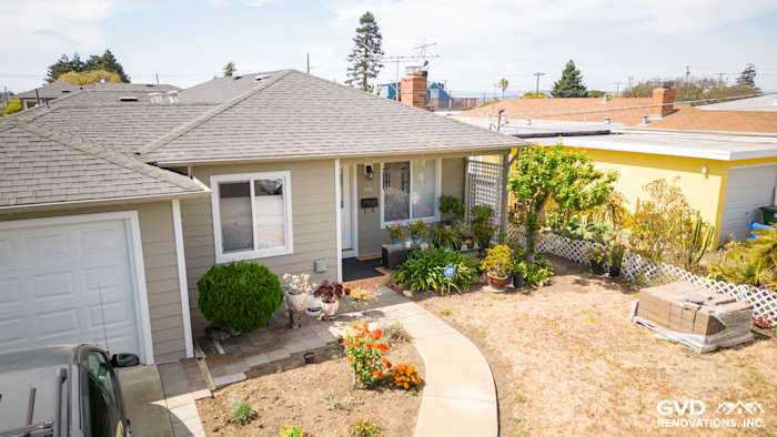 El Cerrito home exterior featuring newly installed James Hardie Monterey Taupe siding and Arctic White trim with landscaping