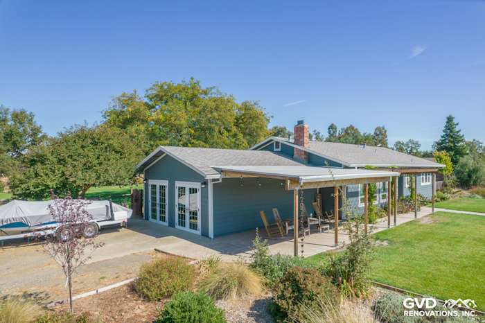 Gray fiber cement siding renovation with a spacious porch, surrounded by landscaping in Wilton, CA