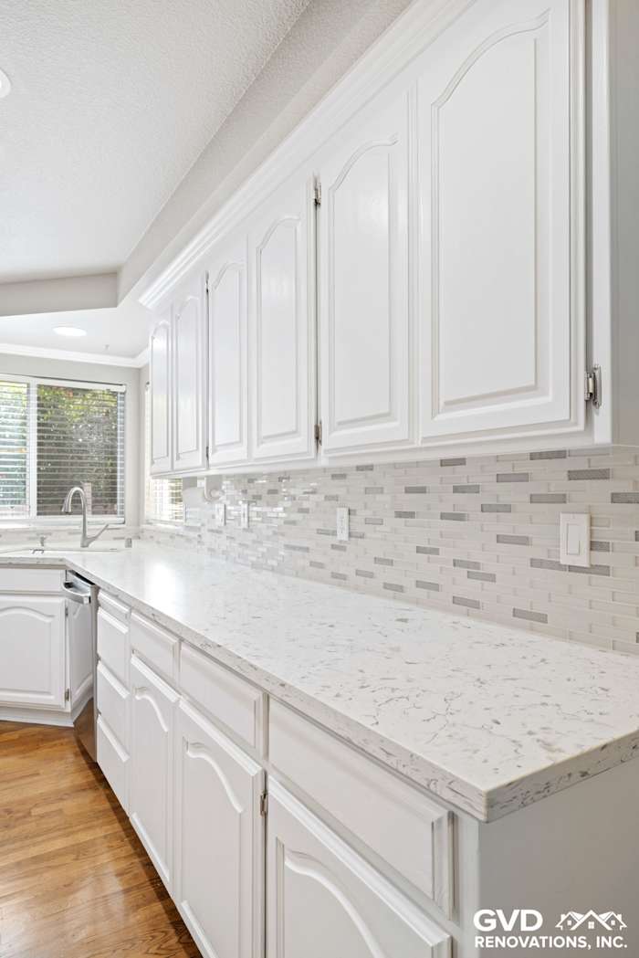 Bright kitchen with white cabinetry, quartz countertop, and stylish subway tile backsplash in Fair Oaks, CA