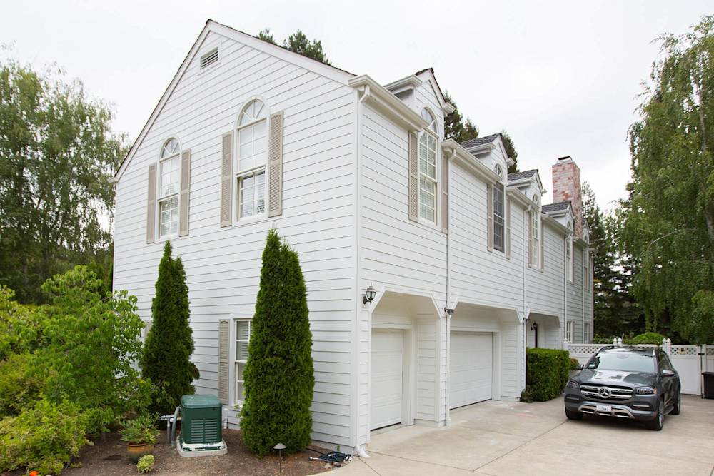 Modern white siding with light brown accents and refreshed landscaping