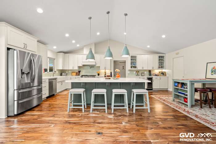 Modern kitchen remodel in Carmichael featuring custom island cabinets, stylish backsplash, and pendant lighting