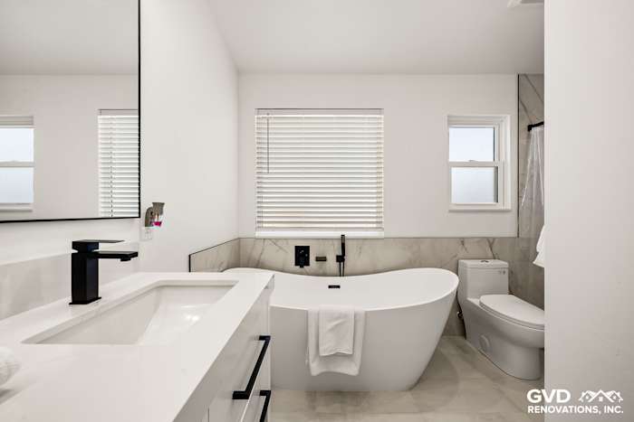 Modern bathroom featuring a freestanding tub, dual vanity, and marble accents in Antelope, CA remodel