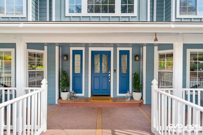 Updated home exterior in Shingle Springs featuring new blue James Hardie siding and double front doors