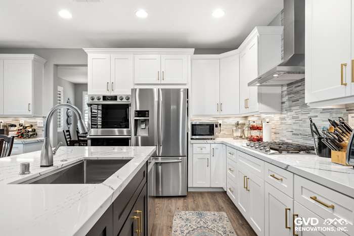 Modern kitchen featuring Cambria custom countertops, white cabinets, stainless steel appliances, and stylish backsplash