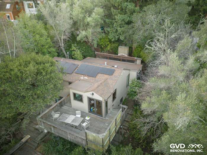 Aerial view of Oakland home featuring brown Hardie siding, Marvin windows, and a wooden deck surrounded by greenery