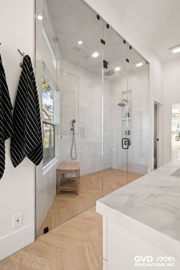 Luxurious bathroom with zero-threshold steam shower, custom tile, and heated floors in El Dorado Hills remodel