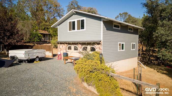 Gray Slate James Hardie siding with Arctic White trim on renovated Meadow Vista home exterior, featuring large windows