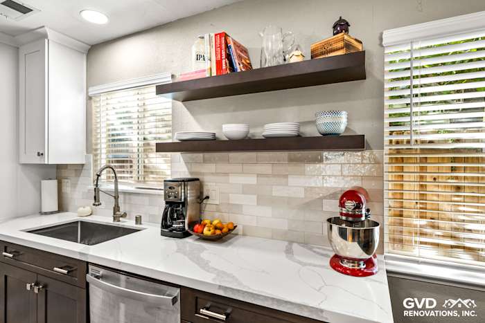 Contemporary kitchen with white quartz countertop, dark cabinetry, open shelving, and a red stand mixer