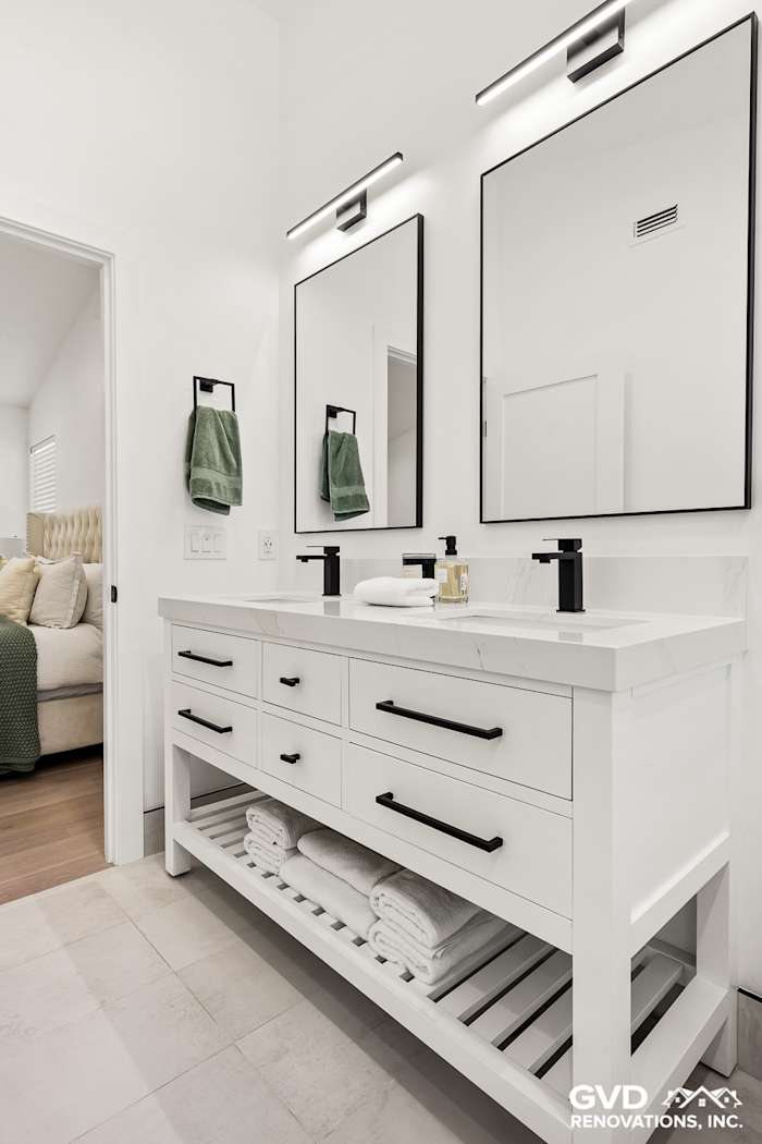 Modern bathroom remodel in Antelope, featuring a sleek dual vanity, contemporary mirrors, and stylish wall sconces