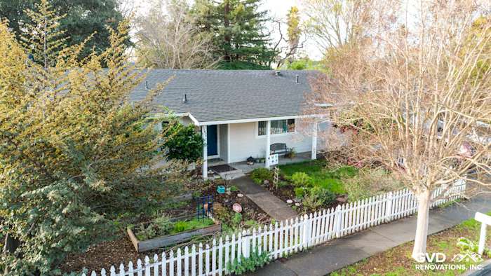 Home exterior featuring James Hardie Cobble Stone siding and Anlin windows with a white picket fence in Napa, CA
