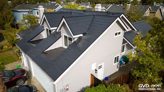Foster City home showcasing Pearl Gray James Hardie siding and Arctic White trim on a modern roof design