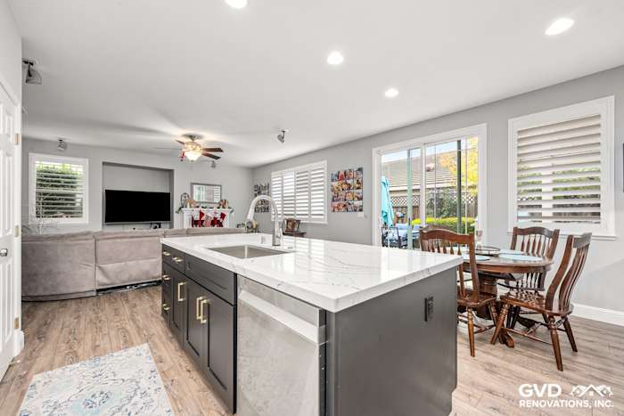 Modern kitchen remodel in Roseville featuring Cambria countertops, dark cabinetry, and a cozy dining area