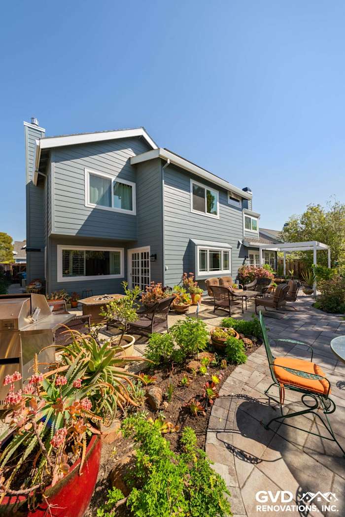 Boothbay Blue HardiePlank siding with Arctic White trim on a Foster City home exterior, featuring landscaping and patio