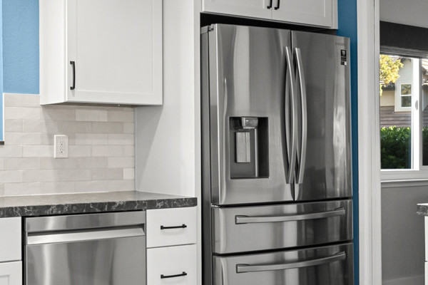 Bright Fair Oaks kitchen remodel featuring white shaker cabinets, stainless steel appliances, and marble-like flooring