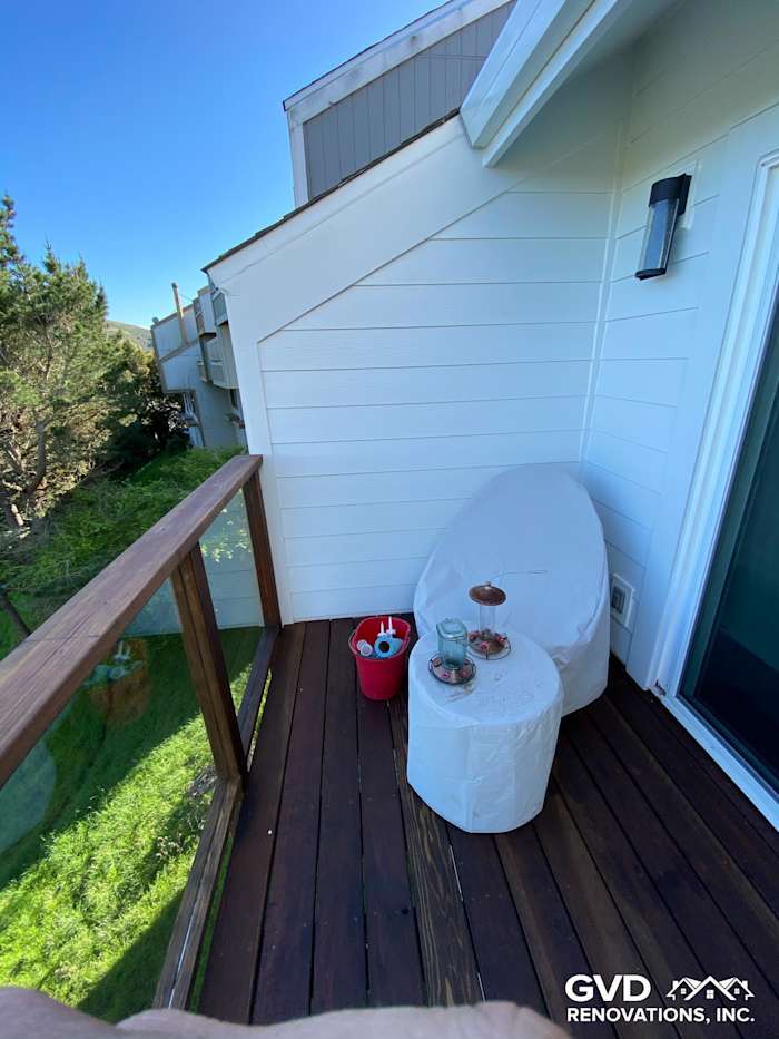 Cozy deck in Mill Valley featuring new James Hardie siding, wooden railing, and outdoor seating area