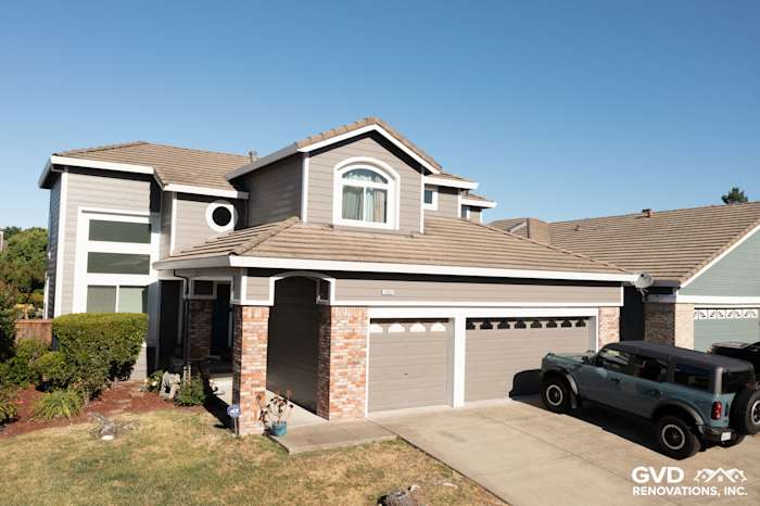 Home exterior featuring Aged Pewter James Hardie lap siding, Arctic White trim, and new vinyl windows in Petaluma
