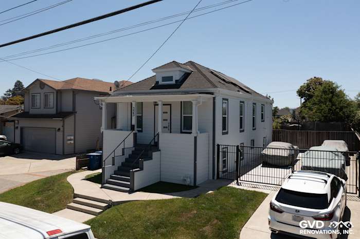 Two-story San Leandro home featuring James Hardie Arctic White Lap Siding and Hardie Trim in a sunny outdoor setting