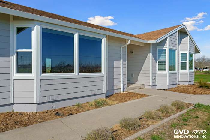 Home exterior featuring Pearl Gray James Hardie Siding and large Anlin Windows in Galt, CA