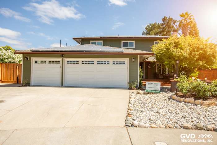 Exterior of home in Pleasanton with new James Hardie siding, updated garage doors, and landscaped driveway