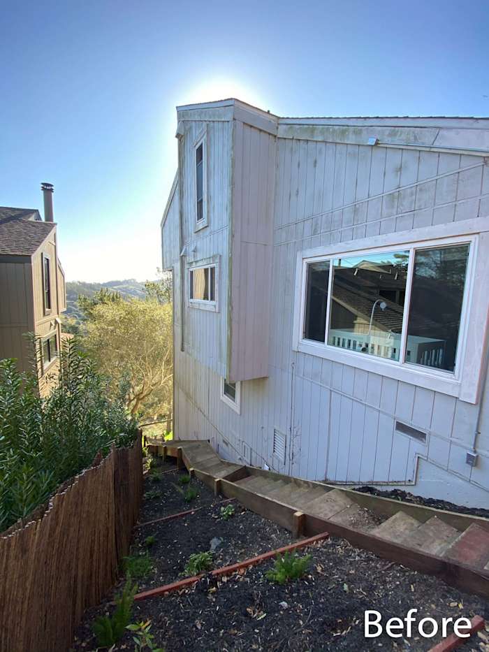 Before shot of a home exterior in Mill Valley, featuring old siding and an unlandscaped yard