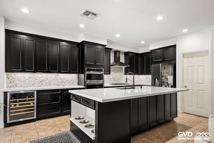 Modern kitchen featuring black Waypoint cabinets, MSI quartz countertops, and a built-in pet feeding station
