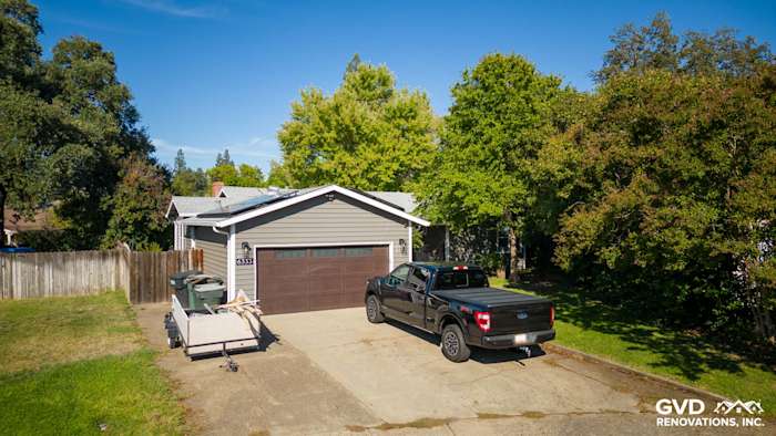 Updated home exterior featuring Alside Prodigy vinyl siding, Milgard windows, and modern garage door in Carmichael