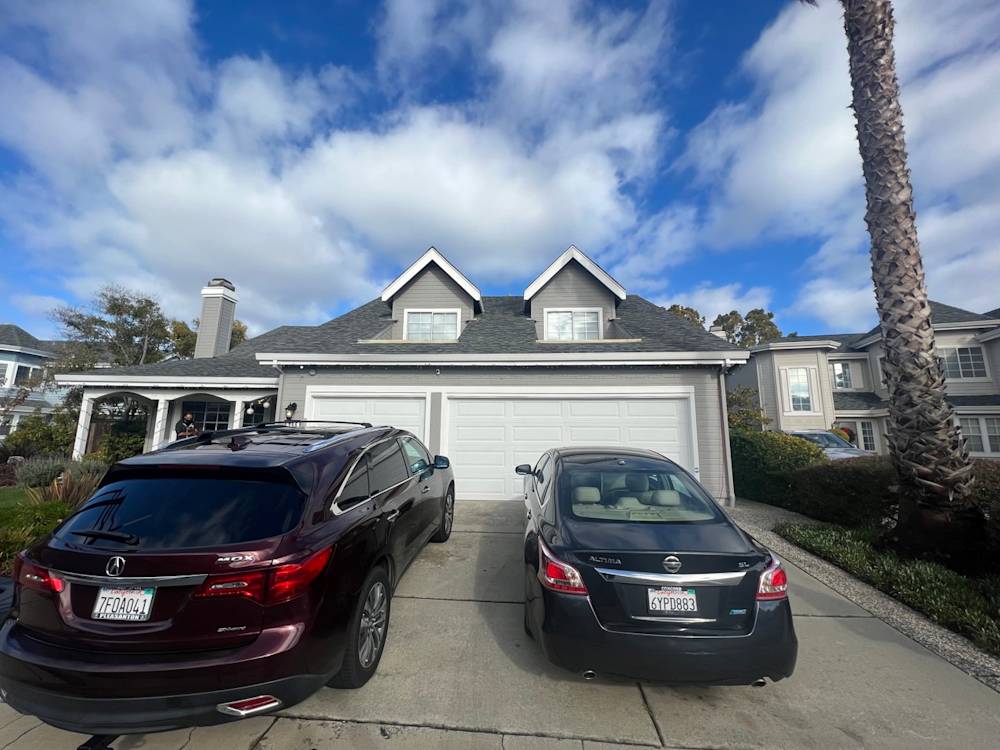 Spacious driveway with two cars, featuring palms and a well-maintained landscape in Northern California