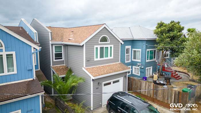 Two-story home exterior featuring Aged Pewter James Hardie siding and Arctic White trim in Oakland, CA