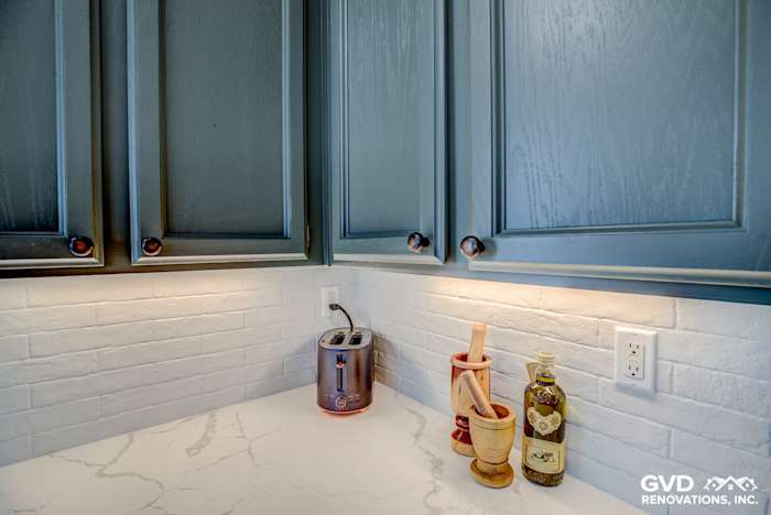 Blue cabinetry with white subway tile backsplash and quartz countertop in remodeled El Dorado Hills kitchen