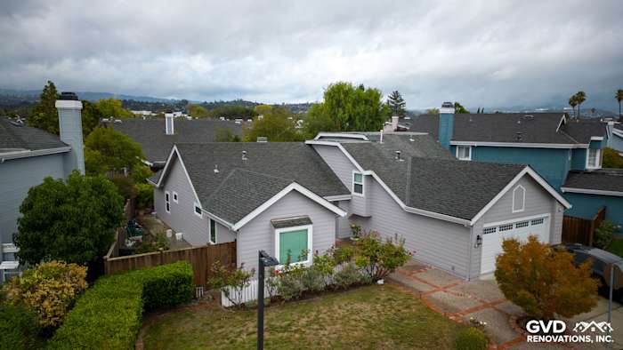 Exterior of a home in Foster City featuring new Pearl Gray James Hardie siding and Milgard windows