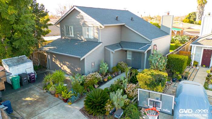 Hayward home exterior featuring Alside Prodigy Vinyl siding in Ageless Slate with vibrant landscaping and driveway