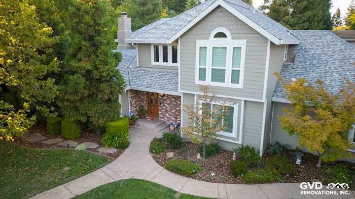 Home exterior featuring James Hardie Monterey Taupe siding with Arctic White trim and stone accents in Fair Oaks