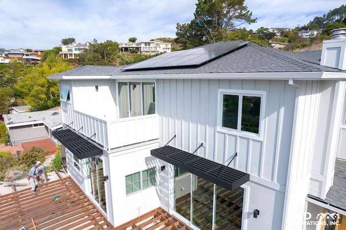 Modern home exterior featuring James Hardie Artisan Lap Siding in white with a gray roof and solar panels