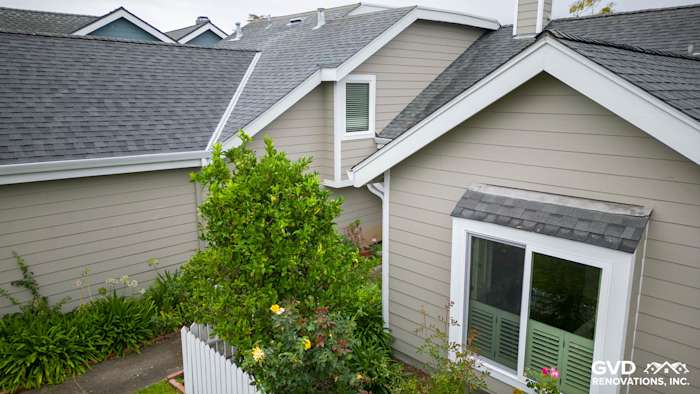 James Hardie siding in Monterey Taupe with Arctic White trim and new Milgard windows in Foster City home exterior